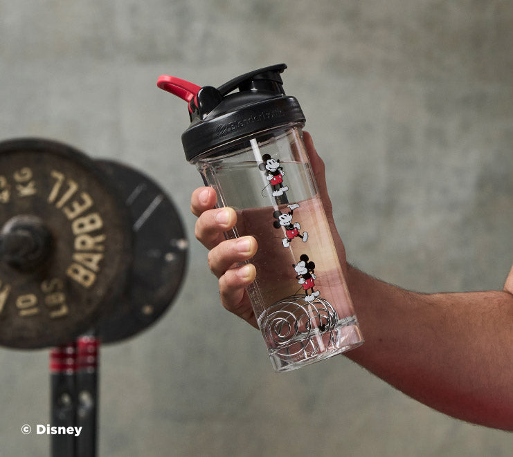 pro-series-d4 Mickey_Mouse_Protein_Shaker_Bottle_Being_Held_In_the_Gym.jpg